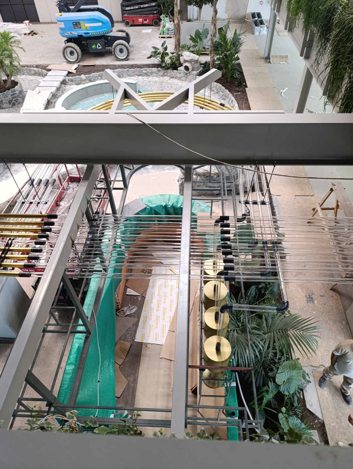 Aerial coffee tube installation during facility commissioning