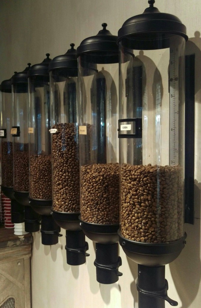 Wall-mounted coffee bean dispenser row in a hospitality space